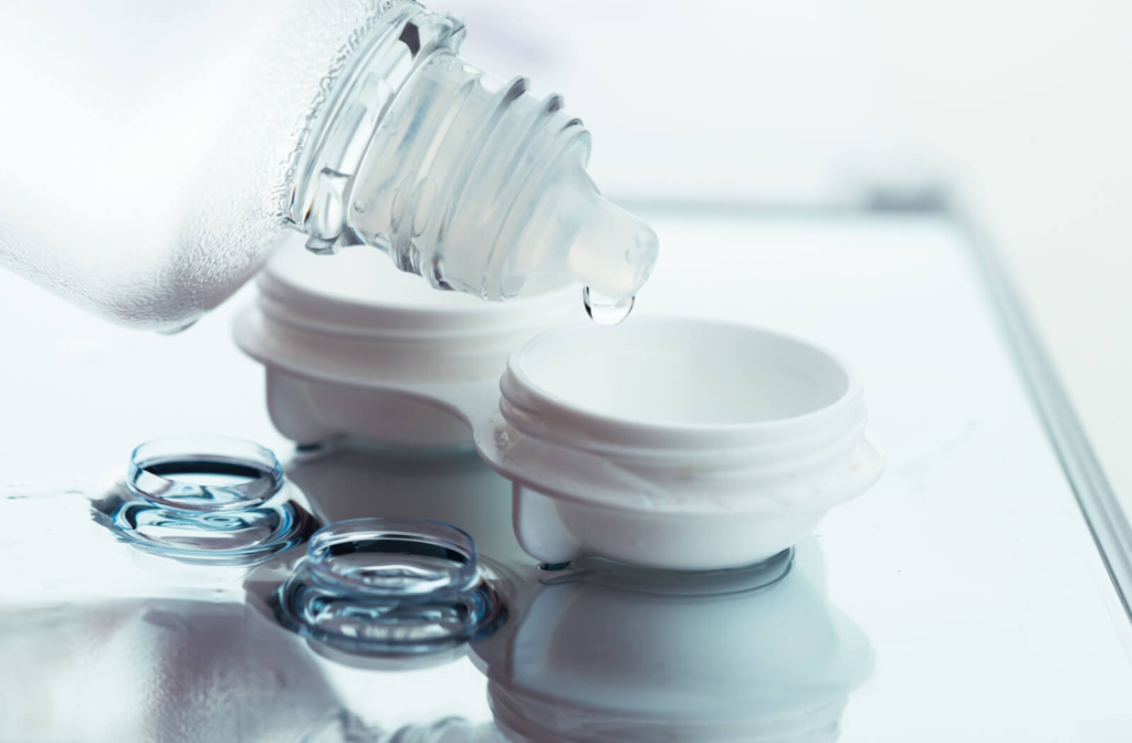 An open contact lens case being filled with a contact lens solution.