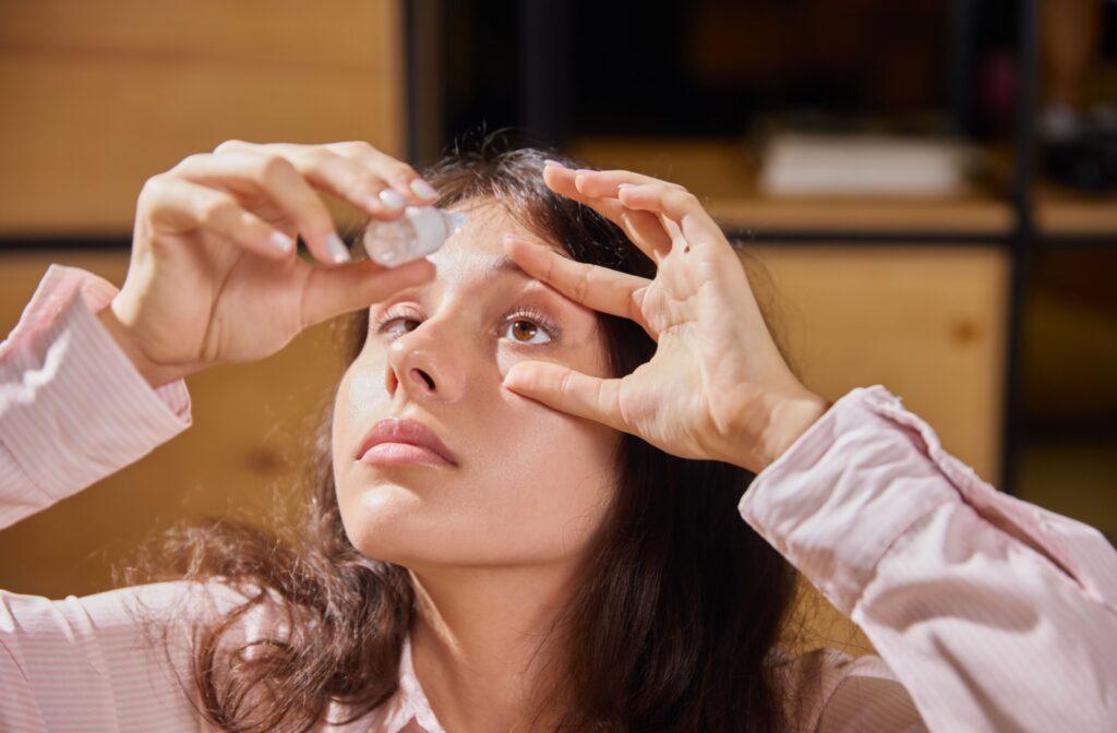 A person holds their eye more open using their fingers to better put eye drops for dry eyes into their eye